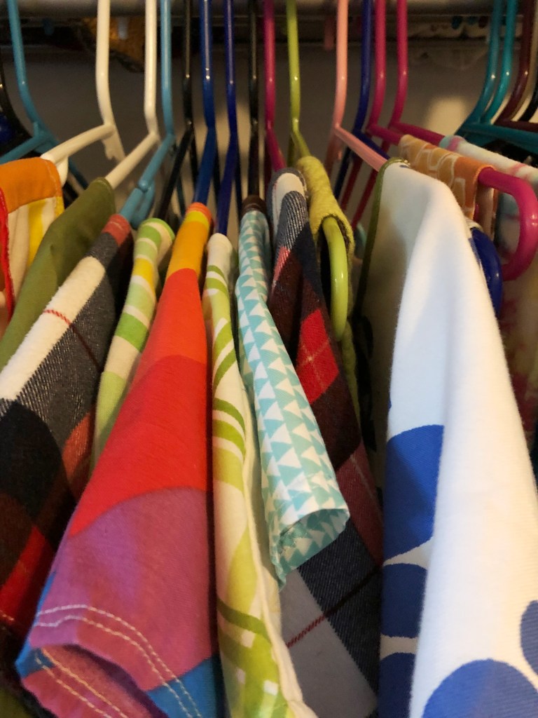 a bunch of handmade clothes hanging