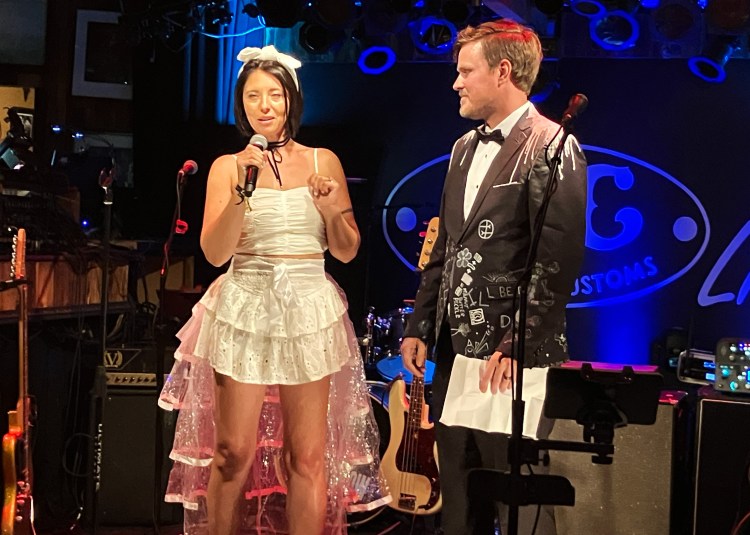 Renee and Matt on stage for their wedding speeches