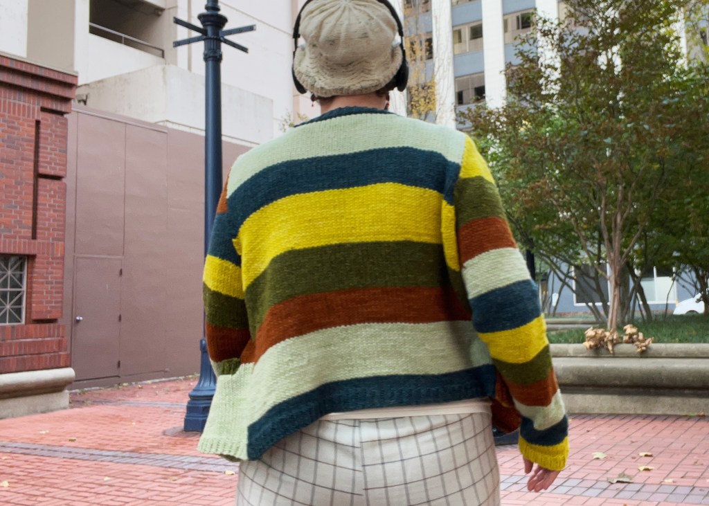 Lee wearing cardigan outside, showing back side