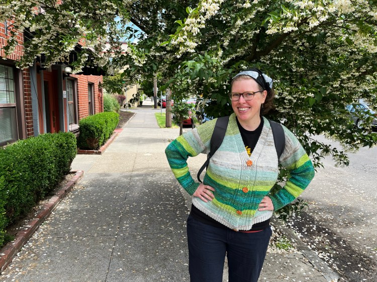 me wearing the cardigan buttoned up with a backpack