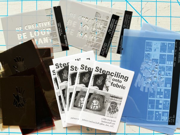 three stacks of different stencils and stenciling mini-zines