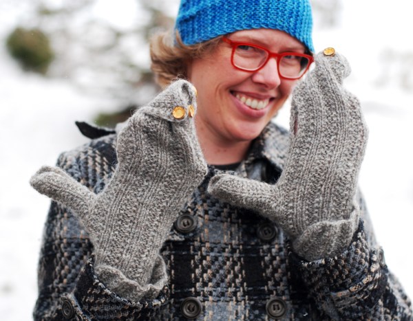 Lee wearing mittens with swirled, buttoned-closed tops