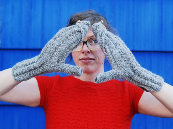 Lee wearing mittens with swirled, buttoned-closed tops