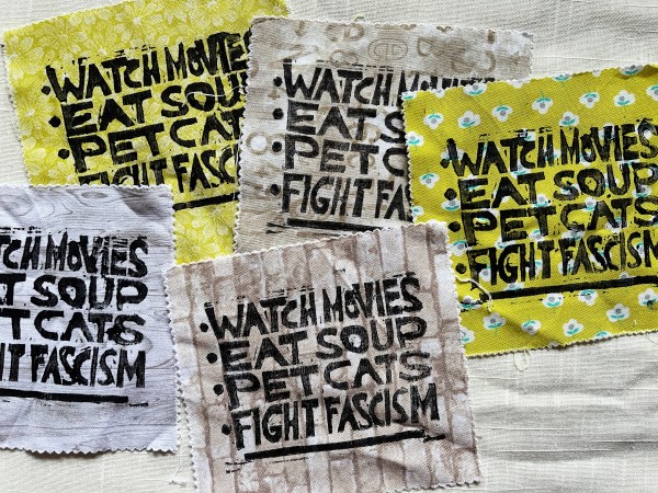 5 patches on different patterned fabrics with block print saying "watch movies, eat soup, pet cats, fight fascism"
