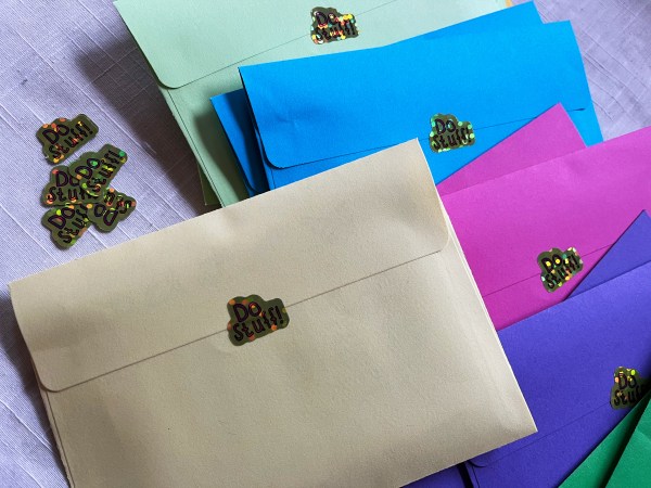 envelopes in different colors with sparkly stickers that say "do stuff!"