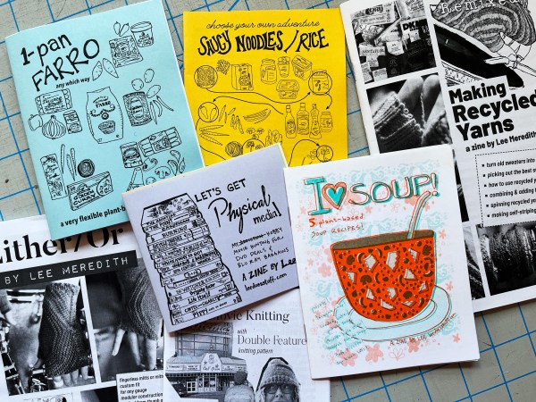 several zines (farro, noodles/rice, recycled yarns, i heart soup, physical media, either/or, movie knitting) spread out